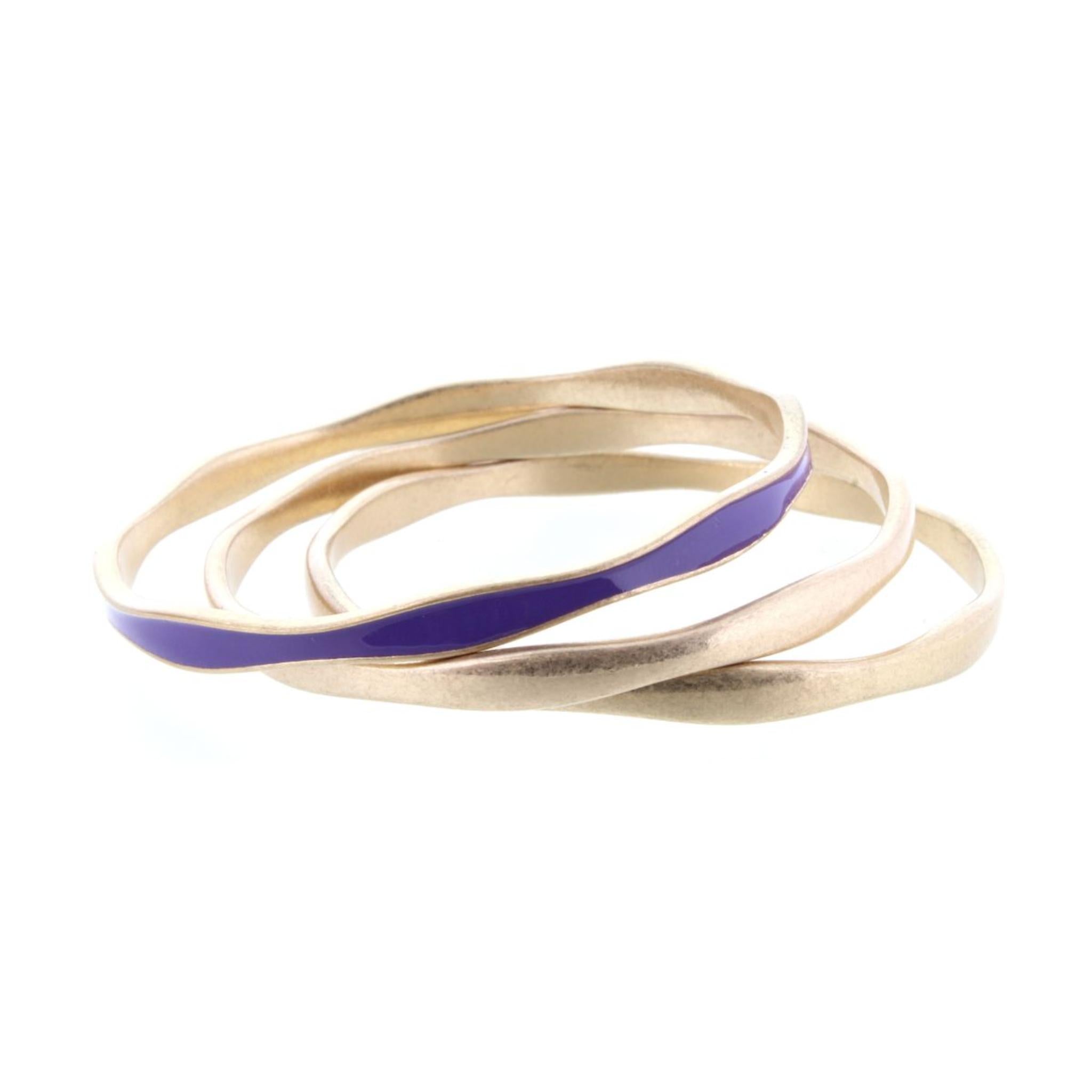 3 Gold Wavy Bangle Bracelets with One Purple Epoxy Accent