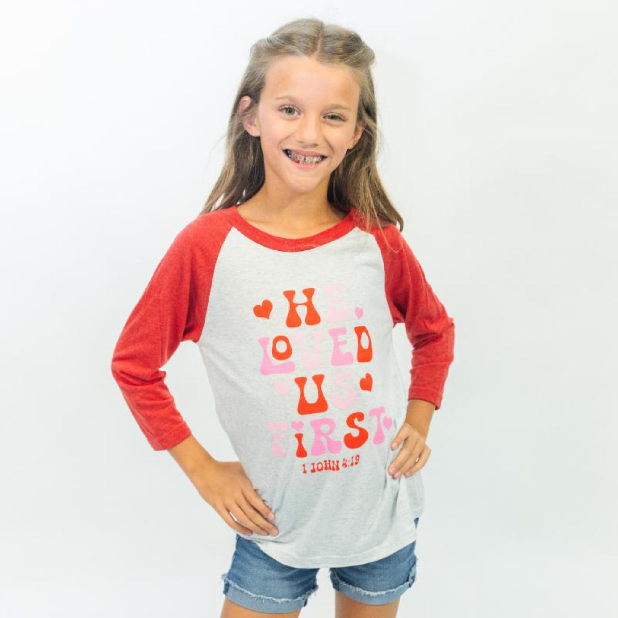Kids He Loved Us First Crew Neck 3/4 Sleeve T-Shirt Assortment, Display Plus 1 Free T-Shirt